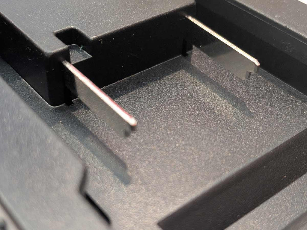 Ozito 18V PXC to RIDGID Plumbing battery adapter - close-up of the two battery-side terminal blades